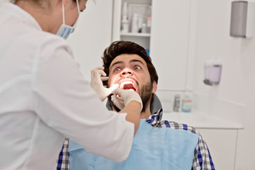 young man and woman in a dental examination at dentist