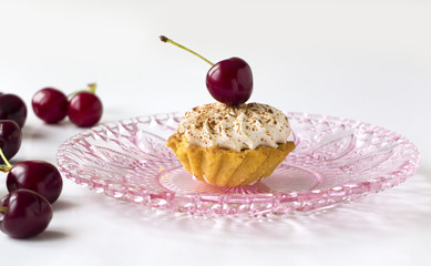 Cupcake with cherries and whipped cream