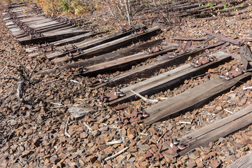 very old railways , abandoned railroad overgrown, destroyed rail track wood, 