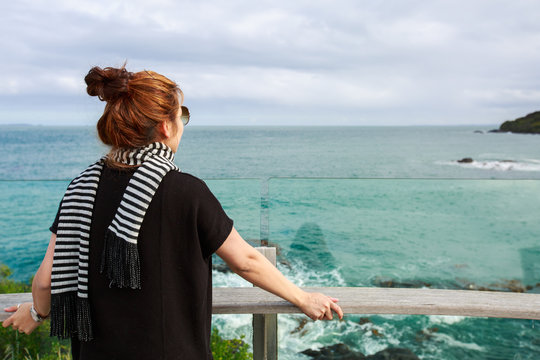 Woman enjoys the view at the view point at Bluff, South Island,