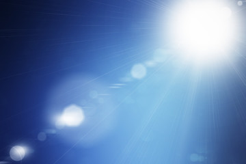 Shining summer sun flare on blue sky background