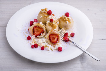 Traditional Czech strawberry quark dumplings with melted butter