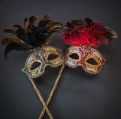 closeup view of theatrical colorful masks on dark grey background