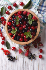 Berry mix in a wooden bowl vertical top view

