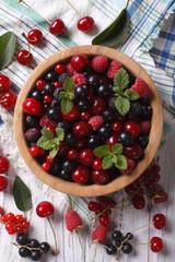 Salad of cherry, raspberry, currant and blackberry vertical top view
