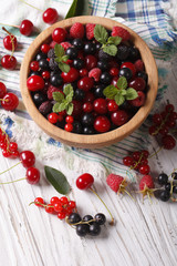 Salad of cherry, raspberry, currant and blackberry close-up. Vertical   © FomaA