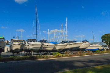 The bows of boats sticking out of the rack 