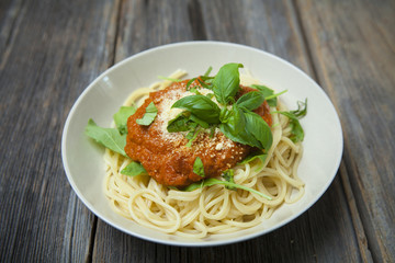 Homemade spaghetti with fresh basil, rucola and Parmesan