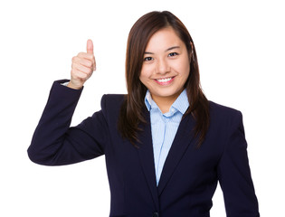 Young businesswoman with thumb up gesture