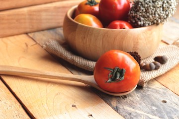Fresh tomato on wood background