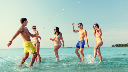 happy friends having fun on summer beach