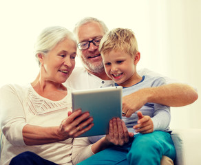 smiling family with tablet pc at home