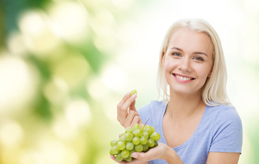 happy woman eating grapes