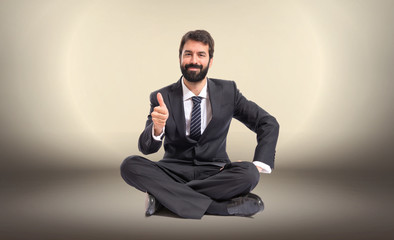 Businessman with thumb up over white background