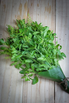 Holy Basil leaves on a wooden background