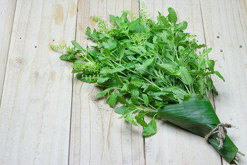 Holy Basil leaves on a wooden background