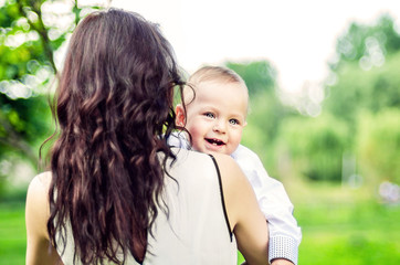 Mother with her little son walking in the park