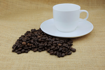 coffee beans and coffee cup on the hemp sack