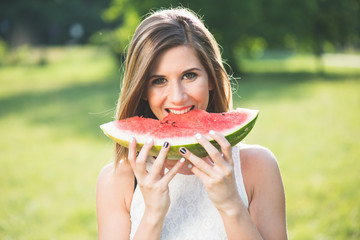 Beautiful girl eating fresh watermelon