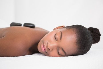 Pretty woman enjoying a hot stone massage