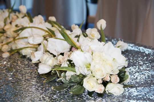 Picture of wedding bouquet of white roses on table as decor