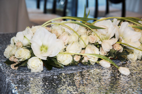Picture of wedding bouquet of white roses on table as decor