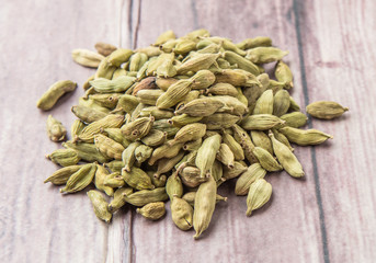 Cardamom spice over weathered wood background