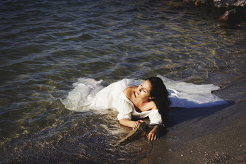 Portrait of young beautiful bride near sea