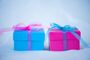 Gift boxes with ribbons on cloth background
