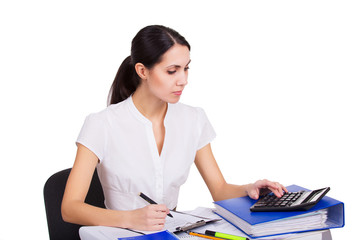 Young business woman working at office, writing and calculating