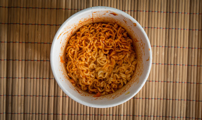 Bowl of Chinese ramen noodles with tomato ketchup. Top view.