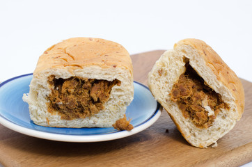 dried shredded pork bread on cutting board on a white background