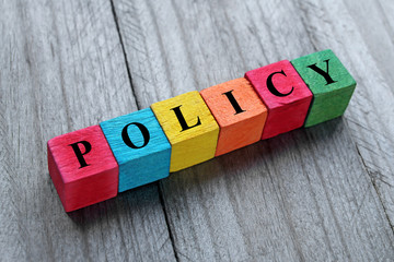 word policy on colorful wooden cubes