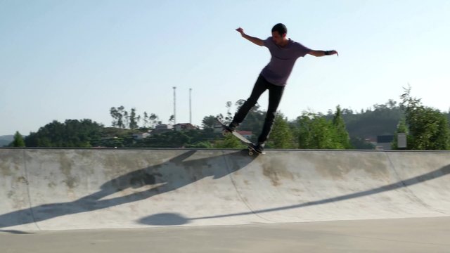 Skateboarder  performing a grind trick on a skatepark.