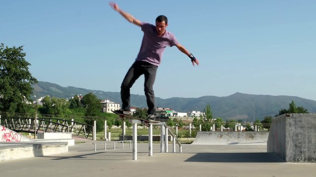 Skateboarder  performing a slide trick on a skatepark.