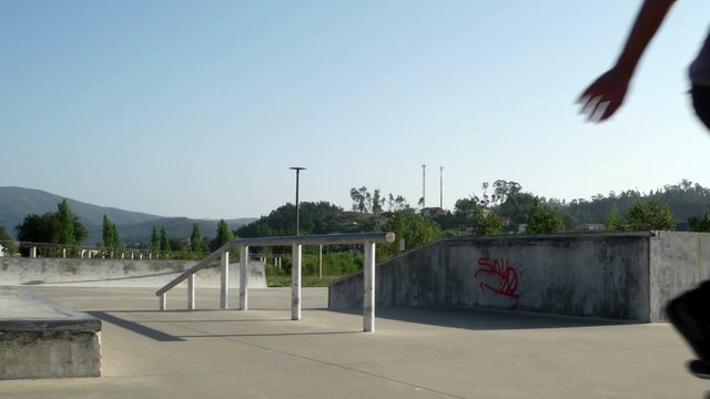 Skateboarder  performing a slide trick on a skatepark.