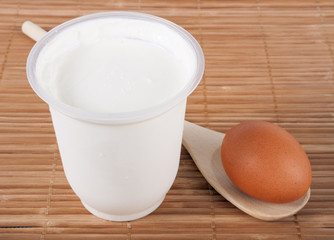 Curd and an egg on a wooden table