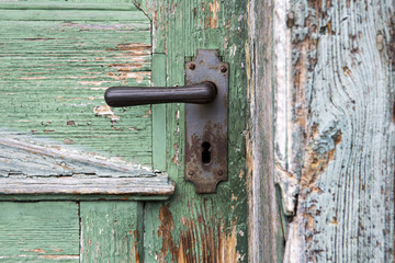 old wooden entrance door with antique door handle