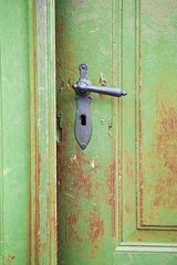 old wooden entrance door with antique door handle