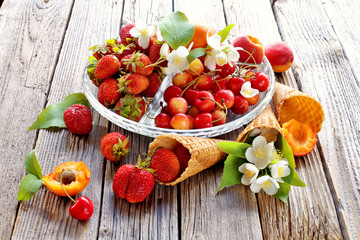 Plate with fruits and waffle cone with strawberries