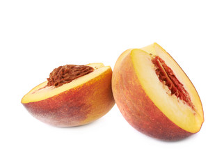 Two halves of a peach fruit isolated