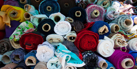 fabric of different colors in rolls