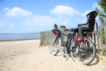 Fototapeta premium Bicycles leaning on fence by the beach