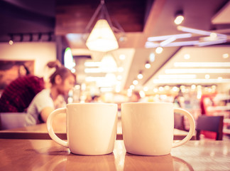 Vintage filter, couple of White coffee cup on wood table with bl