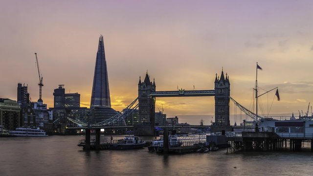Time lapse view of Tower bridge and the Shard in London after sunset, with transition into night