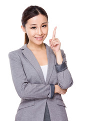 Young businesswoman with finger point up