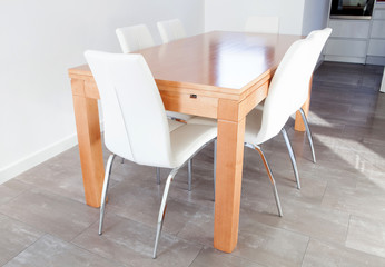 Wooden table and white chairs