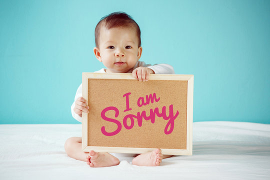Baby writing "I am Sorry" on the board, new family concept, stud