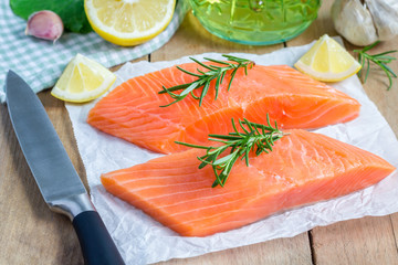 Fresh raw salmon fillet with rosemary and lemon