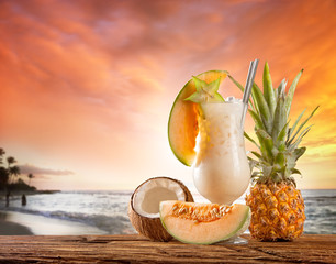 Summer drink with blur beach on background - obrazy, fototapety, plakaty